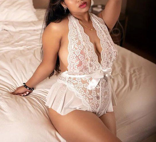 sexy girl sitting in bed in crop-transparent white nighty